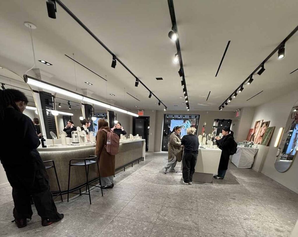 Commercial retail boutique interior renovation by MOMA Construction Group in Williamsburg featuring a modern jewelry showroom with curved stone.