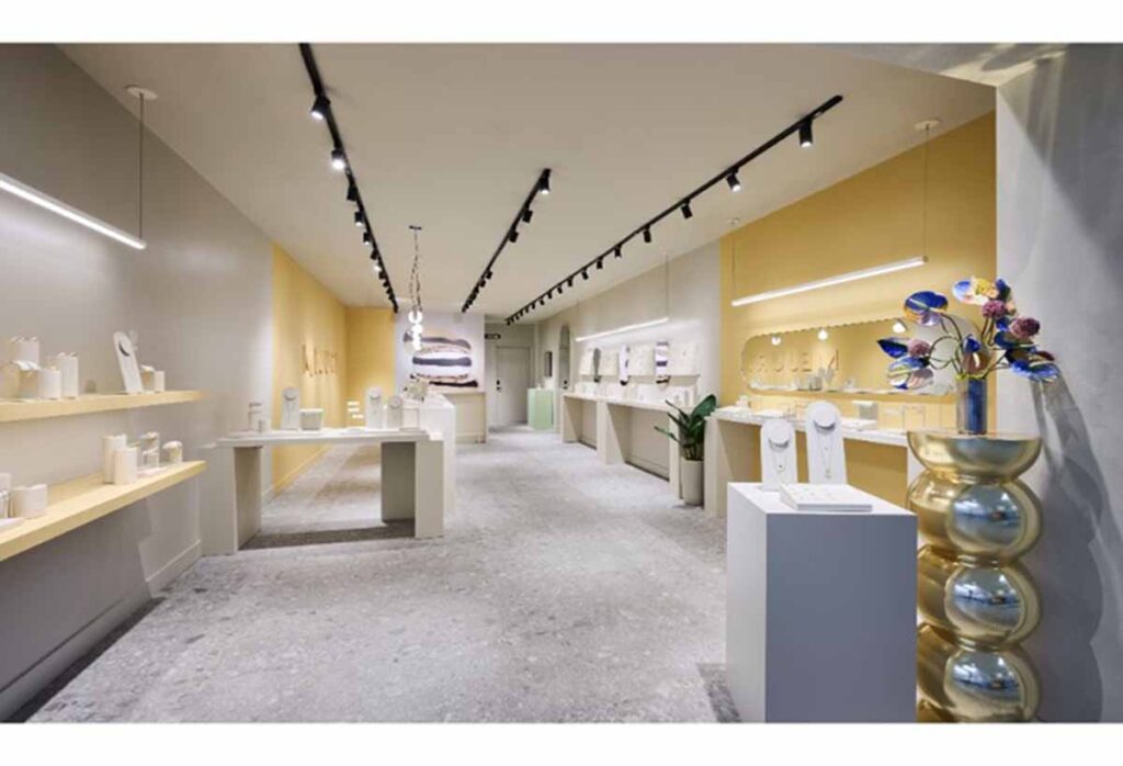 Commercial retail store boutique renovation by MOMA Construction Group in Short HIlls featuring a luxury jewelry sowroom interior with floating display counters and extensive black track lighting grids.