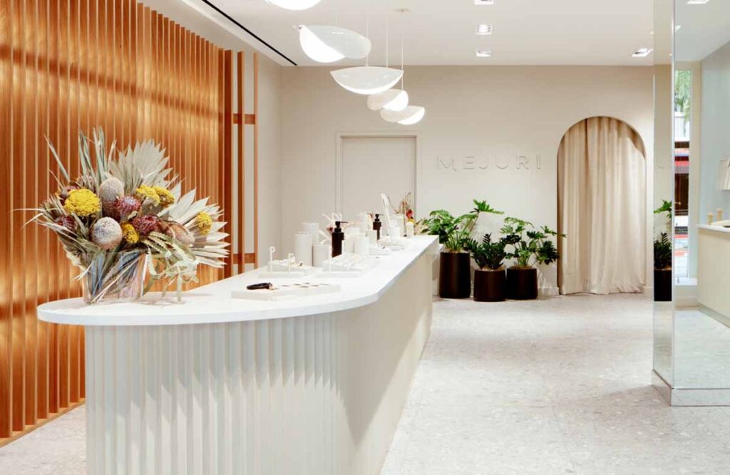 MOMA Construction Group at Santana Row's commercial retail boutique with curved ribbed cash wrap vanity counter and modern pendant lighting.