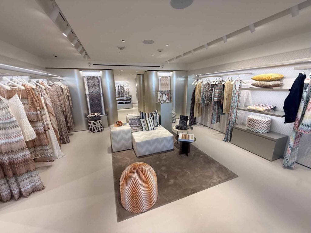 High-end commercial retail interior construction showcasing custom millwork displays and polished minimalist flooring.