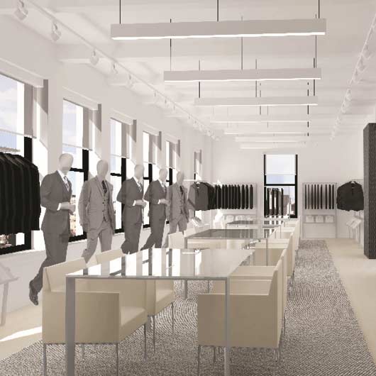A modern menswear showroom built by MOMA Construction Group for Samuelsohn, featuring minimalist glass and metal display tables, comfortable lounge seating, custom clothing racks, and clean industrial track lighting.